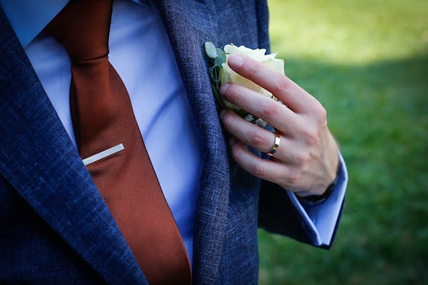 A man in a suit wearing a wedding ring