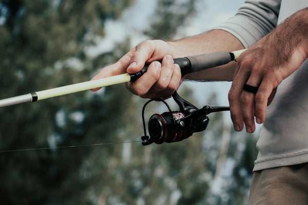 A fisherman wearing a black silicone wedding band